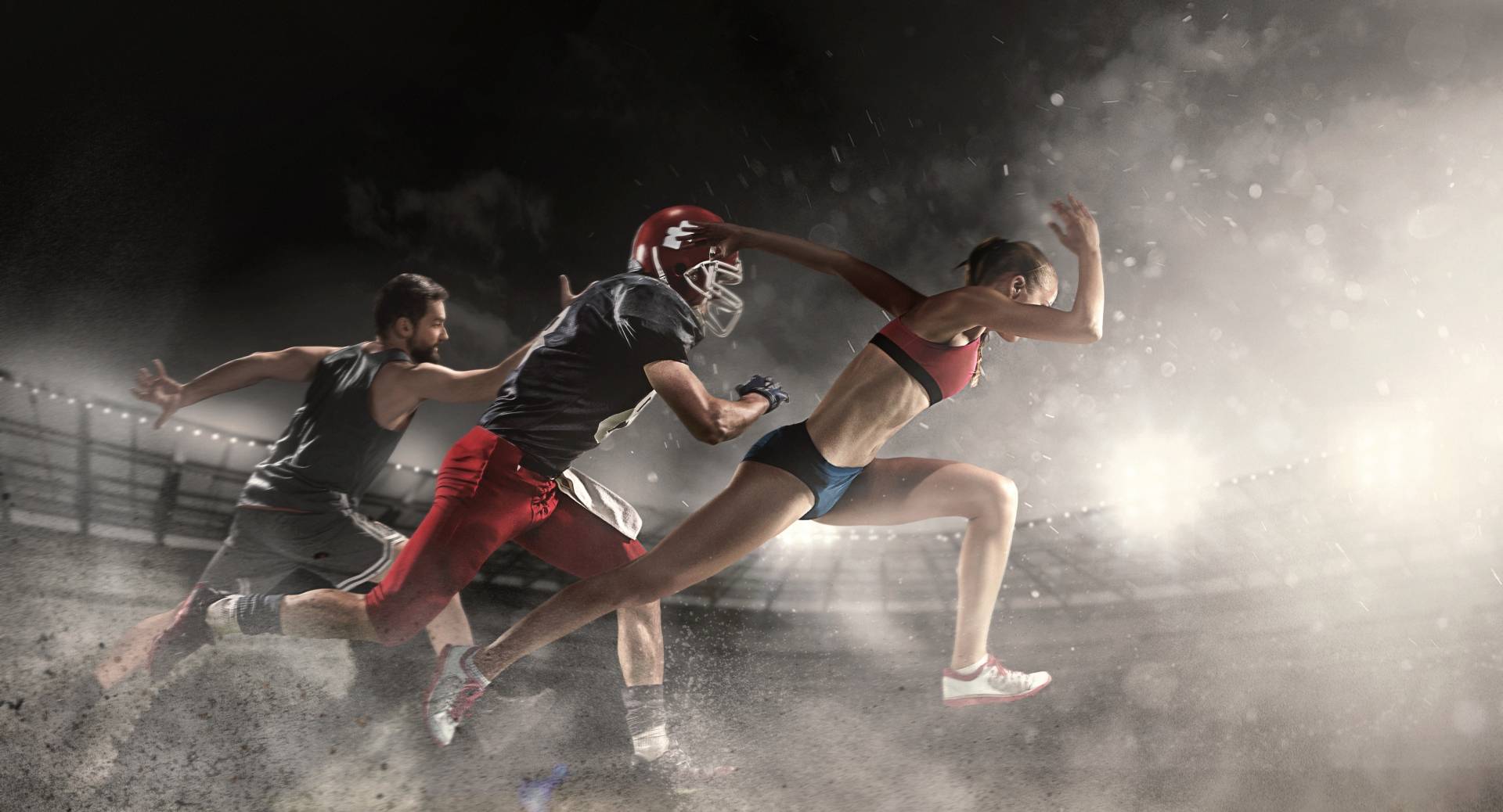 Psychologia sportu: jak odnieść sukces? Zawodnicy z różnych dyscyplin sportowych biegną po stadionie w świetle reflektorów.